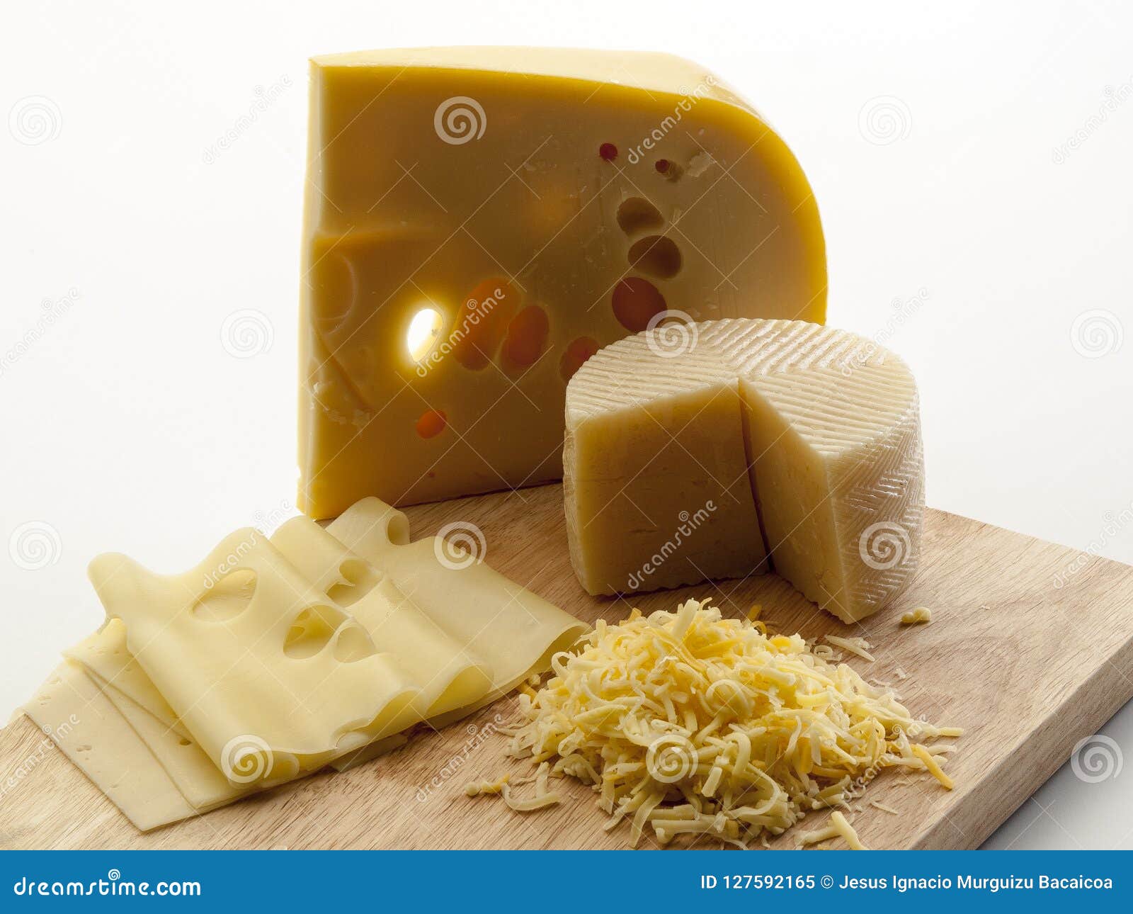 cutting board with two cheeses, grated and sliced Ã¢â¬â¹Ã¢â¬â¹on it